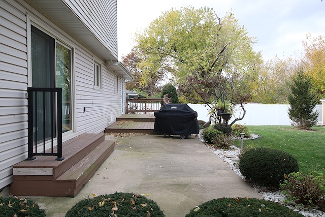 view of patio with area for grilling and a deck