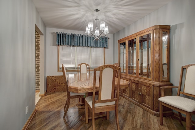 dining room featuring hardwood / wood-style flooring and an inviting chandelier