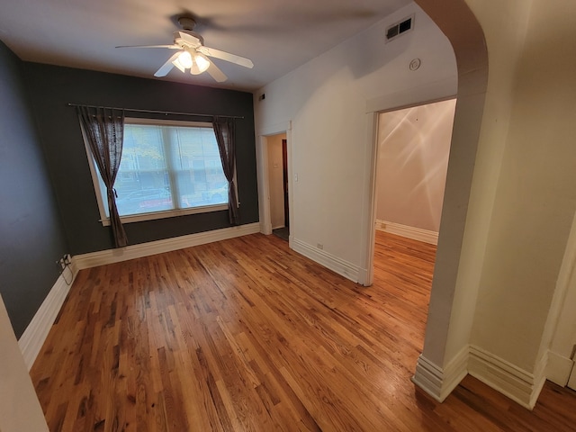 spare room with hardwood / wood-style floors and ceiling fan