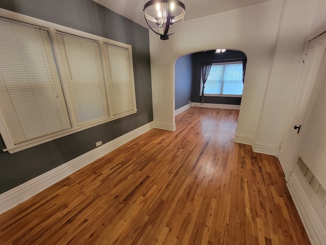 interior space with hardwood / wood-style flooring and an inviting chandelier