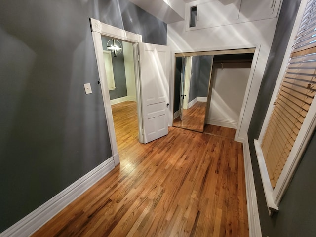 corridor with hardwood / wood-style floors