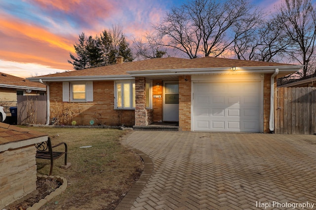 view of front of property with a garage and a lawn