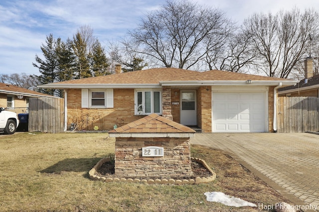 single story home with a garage and a front yard