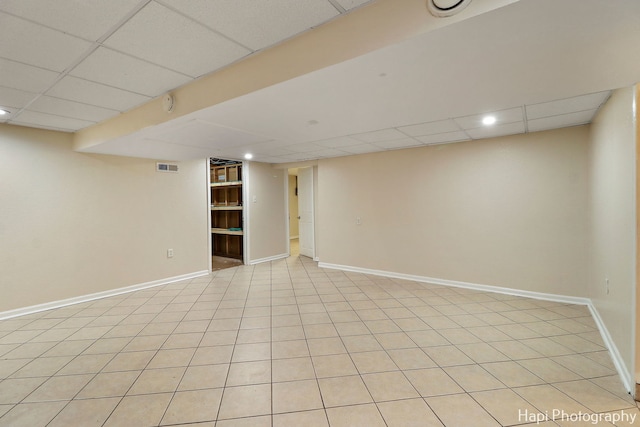 basement with a paneled ceiling