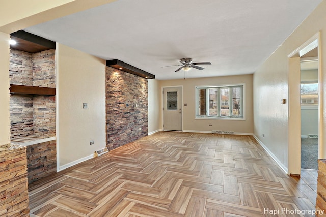 interior space with a healthy amount of sunlight, ceiling fan, and light parquet flooring