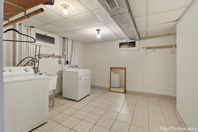 washroom featuring washing machine and clothes dryer and light tile patterned flooring