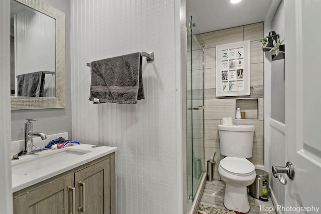 bathroom with vanity, toilet, and an enclosed shower