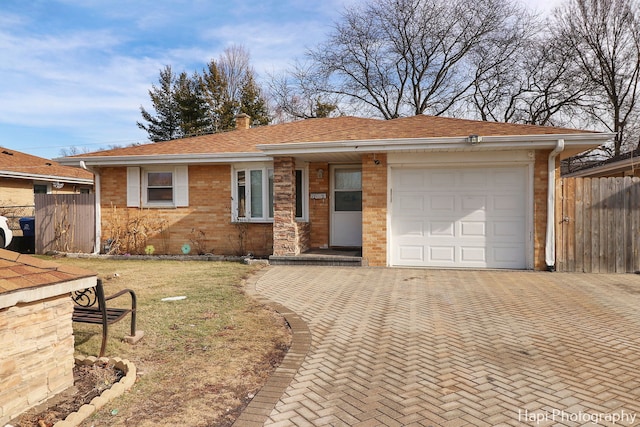 single story home with a garage and a front yard