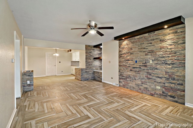 unfurnished living room featuring ceiling fan and light parquet floors