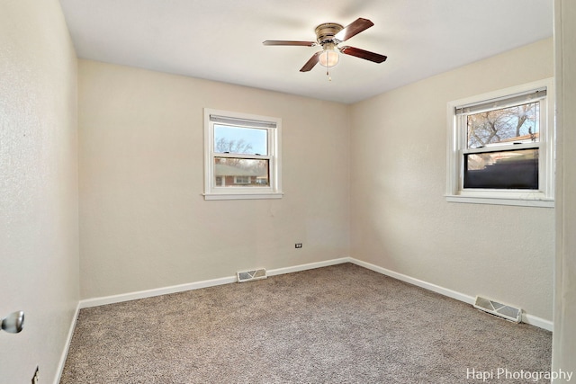 unfurnished room featuring ceiling fan and carpet