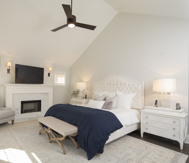 bedroom with vaulted ceiling, wood-type flooring, and ceiling fan