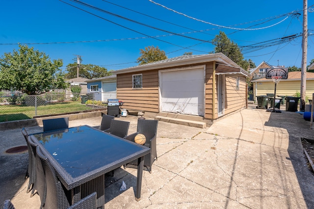 view of patio with an outdoor structure and grilling area