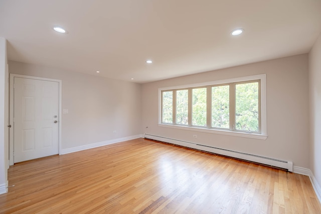 spare room featuring light hardwood / wood-style flooring and a baseboard heating unit