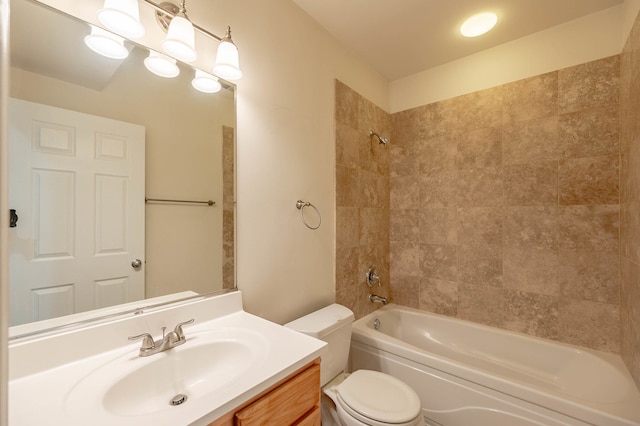 full bathroom with toilet, tiled shower / bath combo, and vanity