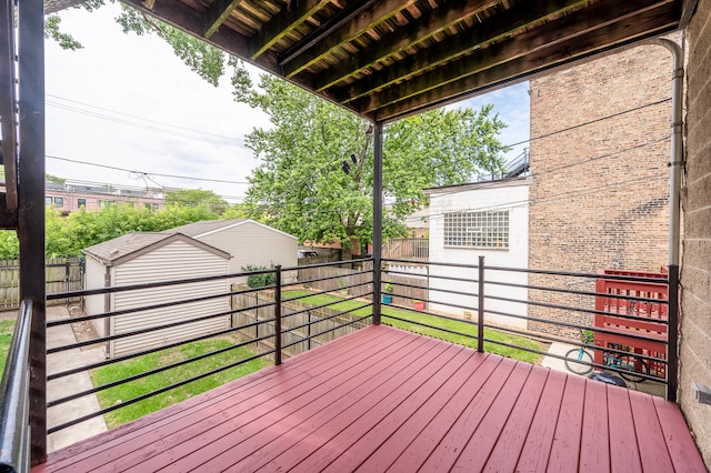 wooden terrace featuring an outdoor structure