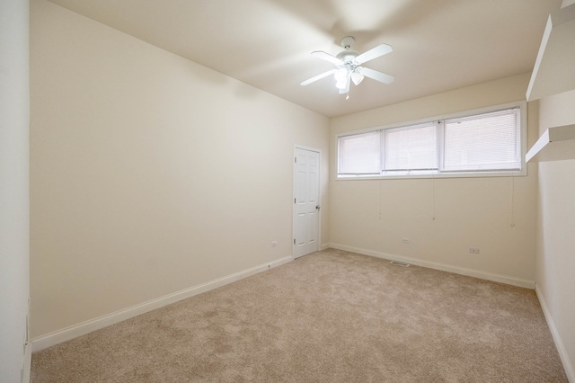 unfurnished room featuring light colored carpet and ceiling fan