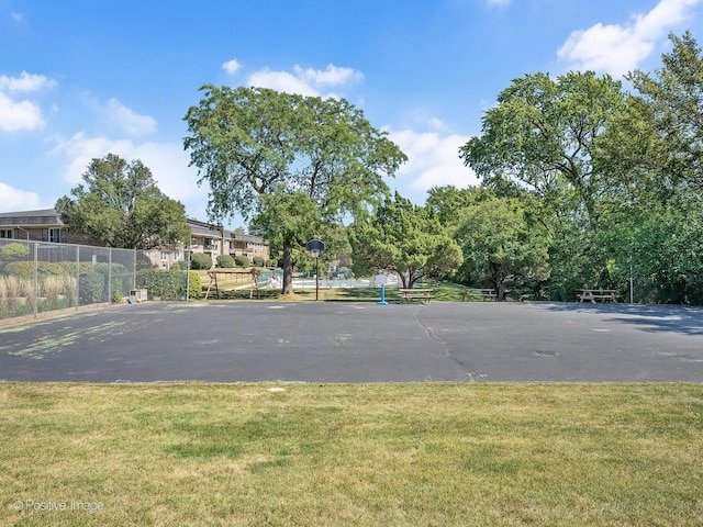 view of basketball court with a lawn