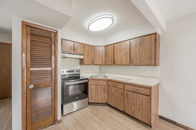 kitchen featuring sink, light wood-type flooring, and stainless steel range with electric cooktop