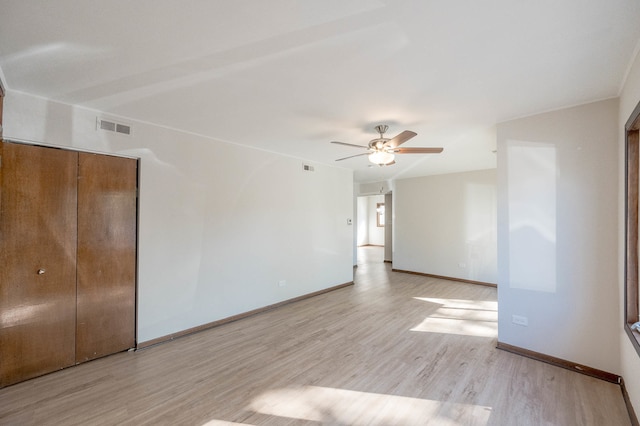 unfurnished room featuring light hardwood / wood-style floors and ceiling fan