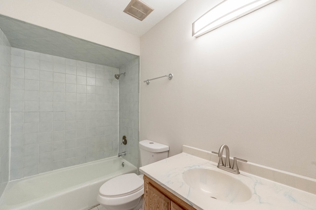 full bathroom with toilet, tiled shower / bath, and vanity