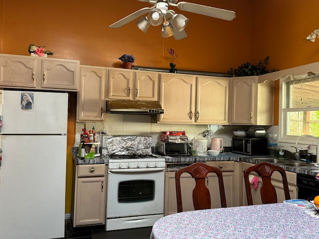 kitchen featuring white appliances, backsplash, sink, and ceiling fan