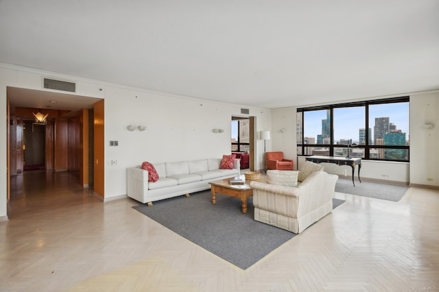 living room with ornamental molding and light parquet flooring