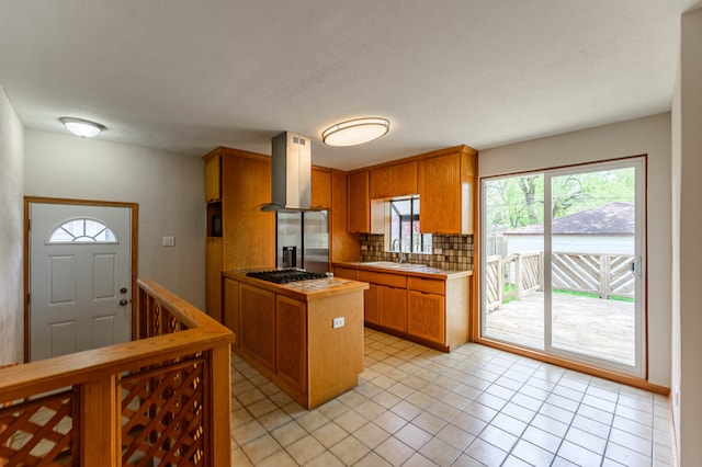 kitchen featuring decorative backsplash, sink, ventilation hood, light tile patterned flooring, and appliances with stainless steel finishes