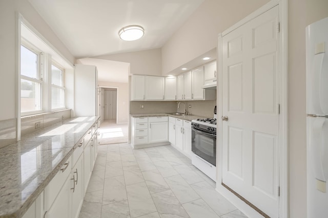 kitchen featuring sink, light stone countertops, vaulted ceiling, white cabinets, and white appliances