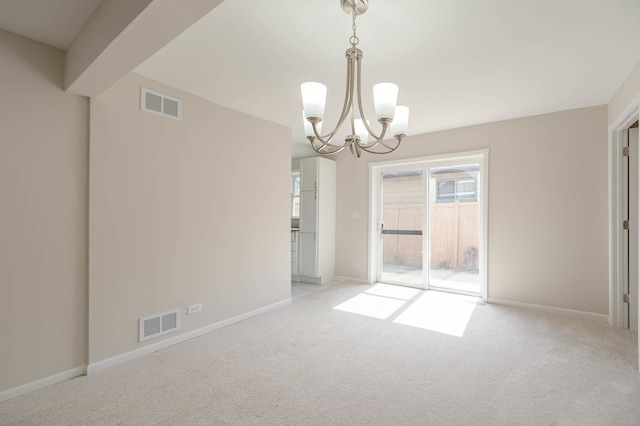 unfurnished dining area featuring a chandelier and light colored carpet