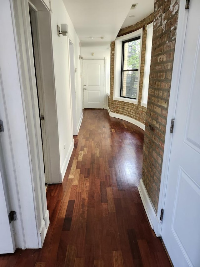 6410 N Hoyne Ave Unit 3E, Chicago, IL 60645 - hall with hardwood / wood-style floors, brick wall, and baseboards