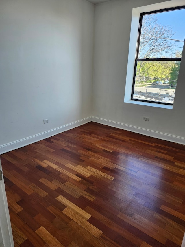 spare room with dark hardwood / wood-style flooring