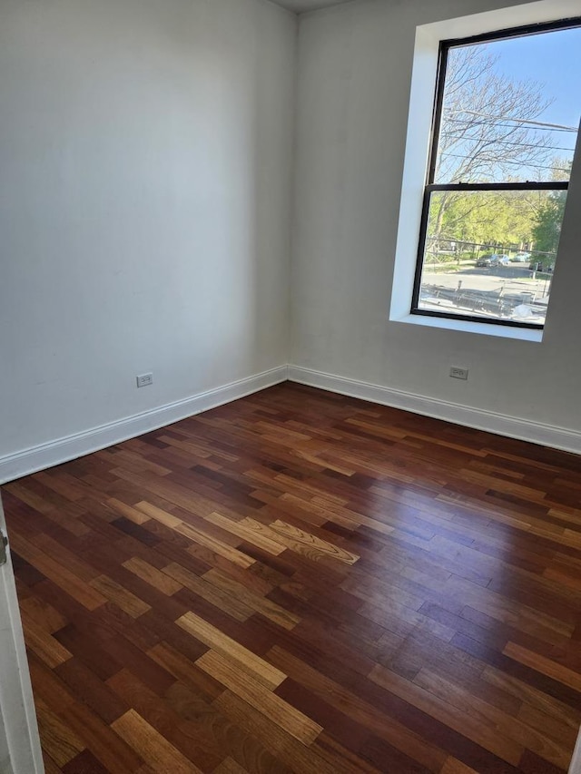 6410 N Hoyne Ave Unit 3E, Chicago, IL 60645 - unfurnished room with dark wood-style flooring and baseboards