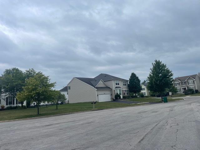 view of road featuring a residential view and curbs