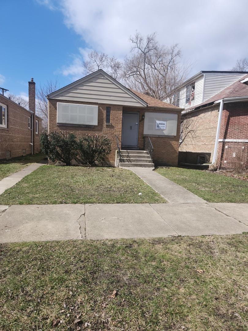 12412 S Stewart Ave, Chicago, IL 60628 - view of front facade featuring brick siding, a front lawn, and entry steps