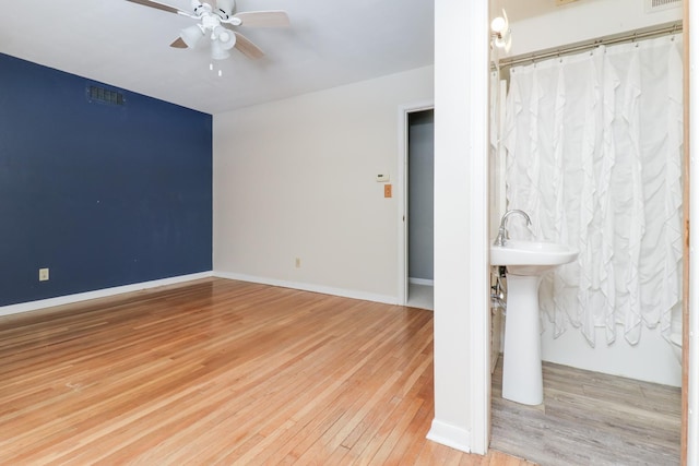 spare room featuring ceiling fan, sink, and light hardwood / wood-style flooring