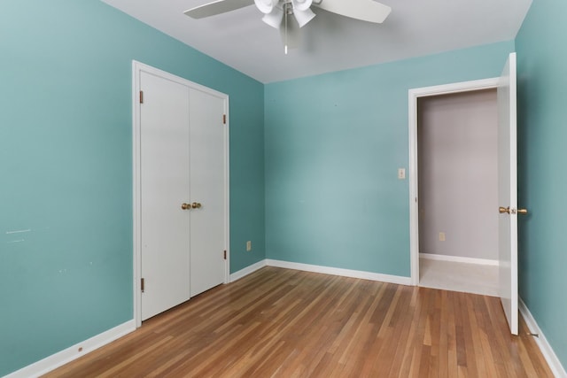 unfurnished bedroom featuring hardwood / wood-style flooring and ceiling fan