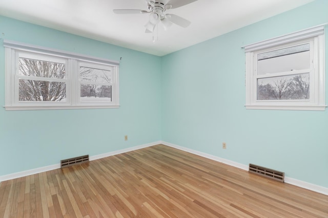 empty room featuring ceiling fan and light wood-type flooring