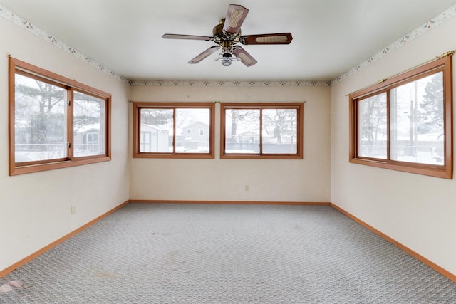 carpeted empty room featuring ceiling fan