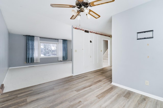 spare room with light hardwood / wood-style floors and ceiling fan