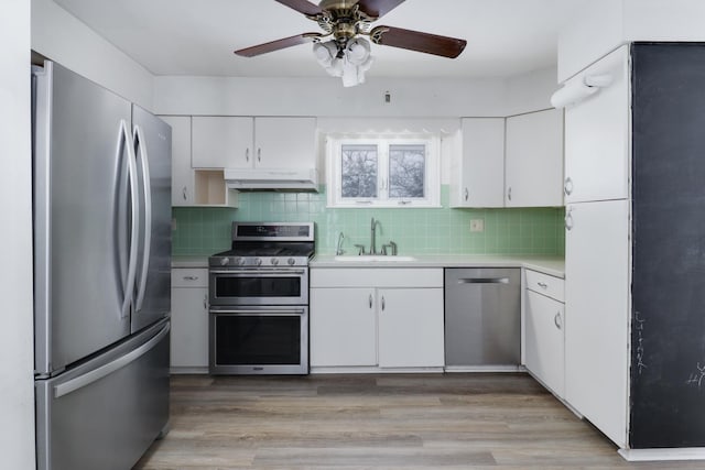 kitchen with backsplash, white cabinetry, sink, and appliances with stainless steel finishes