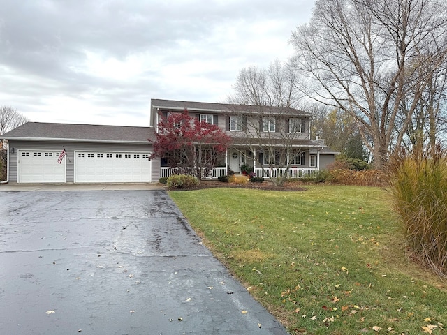 view of front facade featuring covered porch, a garage, and a front yard