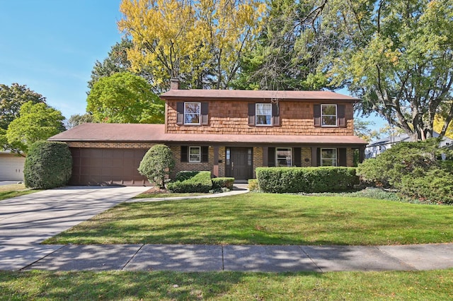 view of front of house with a front yard and a garage