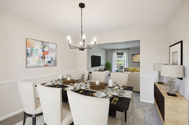 carpeted dining room featuring a chandelier