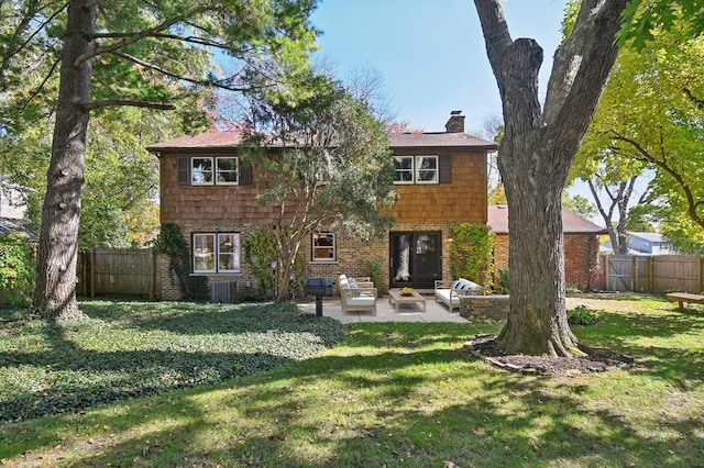 rear view of house featuring outdoor lounge area, a yard, central AC, and a patio area