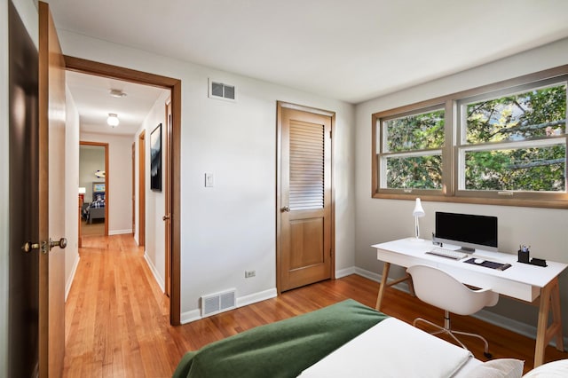 home office with light hardwood / wood-style floors