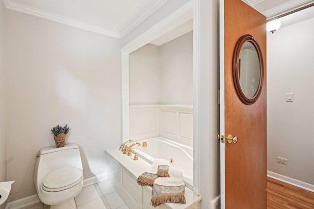 bathroom with tile patterned floors, a bathtub, toilet, and crown molding