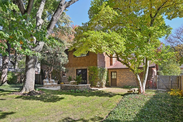 exterior space featuring a front yard and a patio