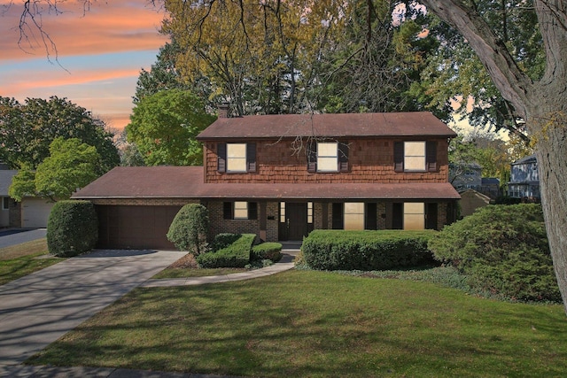 view of front of property featuring a lawn and a garage