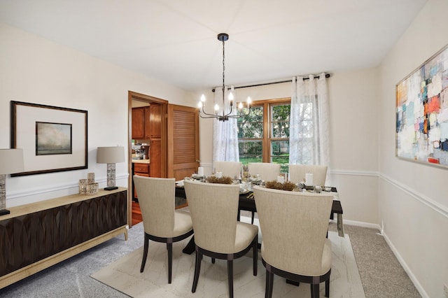 carpeted dining room featuring a notable chandelier