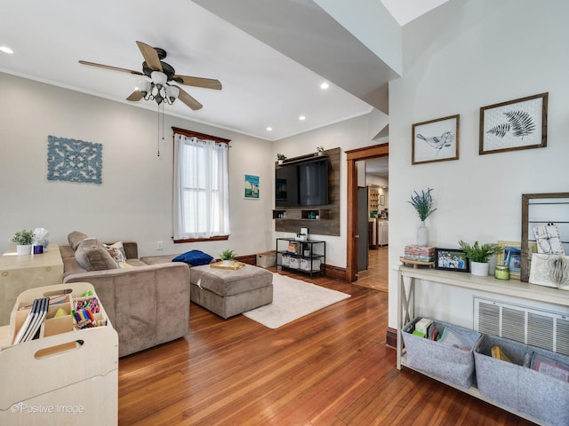 living room featuring hardwood / wood-style floors, ceiling fan, and ornamental molding